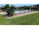 Community pool surrounded by landscaping, with wrought iron fencing and grassy lawn at 1640 Juno Trl # 101A, Astor, FL 32102