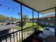 View from the balcony with green space, trees, and covered parking, perfect for relaxing outdoors at 1640 Juno Trl # 205B, Astor, FL 32102