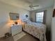 Bright bedroom with ceiling fan, window, dresser, lamps, and comfortable decor at 1640 Juno Trl # 205B, Astor, FL 32102