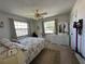 Bright bedroom with two windows, dresser, mirror, ceiling fan and decorative accents at 1640 Juno Trl # 205B, Astor, FL 32102