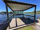 Dockside view of boat house and lift on tranquil waters at 1640 Juno Trl # 205B, Astor, FL 32102