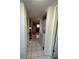 Hallway with tiled flooring, showing washer and dryer and view to kitchen at 1640 Juno Trl # 205B, Astor, FL 32102