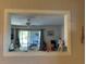 View of living room from kitchen pass through window with ceiling fan, TV and comfortable furnishings at 1640 Juno Trl # 205B, Astor, FL 32102