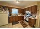 Functional kitchen with wood cabinets, white appliances, and tile flooring at 1640 Juno Trl # 205B, Astor, FL 32102