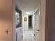 Hallway laundry space with stackable washer and dryer and a view to the flamingo bathroom at 1640 Juno Trl # 205B, Astor, FL 32102