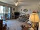 Spacious living room with access to a screened lanai and comfortable seating at 1640 Juno Trl # 205B, Astor, FL 32102