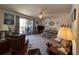 Inviting living room with comfortable furniture, a view of the lanai, and a ceiling fan at 1640 Juno Trl # 205B, Astor, FL 32102