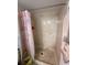Shower with flamingo curtain, and neutral marble-style tiled surround at 1640 Juno Trl # 205B, Astor, FL 32102