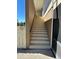 Exterior stairway with railing leading to the upper-level condo entrance at 1640 Juno Trl # 205B, Astor, FL 32102