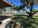 Scenic water view with benches under mature trees, perfect for relaxation and enjoying the serene environment at 1640 Juno Trl # 205B, Astor, FL 32102