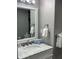 Clean bathroom with a mirror, towels, and under-sink storage at 1909 S Atlantic Ave # 703, Daytona Beach, FL 32118