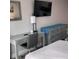 Bedroom featuring a grey dresser, a desk, a television, and a mirror at 1909 S Atlantic Ave # 703, Daytona Beach, FL 32118