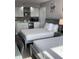 Clean bedroom with two beds, a kitchenette, and a desk at 1909 S Atlantic Ave # 703, Daytona Beach, FL 32118