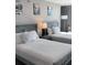 Clean bedroom with two beds and art at 1909 S Atlantic Ave # 703, Daytona Beach, FL 32118