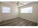 Bright bedroom features wood floors, ceiling fan, and natural light from two large windows at 1920 E Edgewood Dr # D1, Lakeland, FL 33803