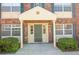Inviting entryway of this condo with decorative columns and well-manicured shrubbery at 1920 E Edgewood Dr # D1, Lakeland, FL 33803