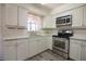 Modern kitchen boasts stainless steel appliances and white cabinetry for a clean look at 1920 E Edgewood Dr # D1, Lakeland, FL 33803