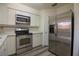 Well-equipped kitchen features stainless steel appliances and bright white cabinetry at 1920 E Edgewood Dr # D1, Lakeland, FL 33803