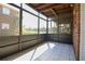 Enclosed lanai with tile flooring and views of the community and tennis court at 1920 E Edgewood Dr # D1, Lakeland, FL 33803