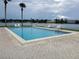 Community pool by the lake, surrounded by lounge chairs and scenic views at 1920 E Edgewood Dr # D1, Lakeland, FL 33803