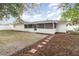 Backyard with screened in porch, mulch beds, and a stepping stone walkway at 1928 South Blvd, Maitland, FL 32751