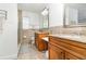 Bathroom featuring double sinks, granite countertops, and a glass door shower at 1928 South Blvd, Maitland, FL 32751