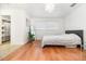Bright bedroom featuring a walk-in closet, ample natural light, and hardwood flooring at 1928 South Blvd, Maitland, FL 32751