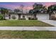 Well-maintained single story home with manicured lawn, a two-car garage, and a stone accent wall at 1928 South Blvd, Maitland, FL 32751