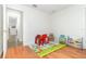 Bright and airy playroom with hardwood floors and a colorful play mat at 1928 South Blvd, Maitland, FL 32751
