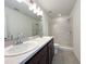 Bathroom with double sinks, gray cabinets, and a walk-in shower at 2117 Lincoln Ln, Bartow, FL 33830