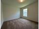 Well-lit bedroom with plush carpet and a window offering natural light at 2117 Lincoln Ln, Bartow, FL 33830