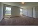 Neutral bedroom featuring carpet flooring, windows providing natural light, and a closet at 2117 Lincoln Ln, Bartow, FL 33830