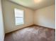 Cozy bedroom featuring neutral carpet and a bright window allowing ample natural light at 2117 Lincoln Ln, Bartow, FL 33830