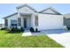 Charming single-Gathering home featuring a manicured lawn, stone accents, and a two-car garage at 2117 Lincoln Ln, Bartow, FL 33830