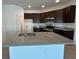 Kitchen featuring dark wood cabinets, granite countertops, stainless steel appliances, and a large island at 2117 Lincoln Ln, Bartow, FL 33830