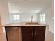 Kitchen island with stainless steel sink, granite countertop, and wooden cabinets and stainless steel dishwasher at 2117 Lincoln Ln, Bartow, FL 33830