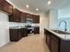 Stylish kitchen featuring dark wood cabinets, granite countertops, and stainless steel appliances at 2117 Lincoln Ln, Bartow, FL 33830