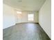 Bright living room featuring wood-look tile floors, a large window, and a white front door at 2117 Lincoln Ln, Bartow, FL 33830