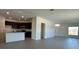 Open-concept living space with a kitchen island, dark cabinets, tile flooring, and abundant natural light at 2117 Lincoln Ln, Bartow, FL 33830
