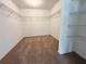 Spacious walk-in closet with wire shelving and carpet flooring at 2117 Lincoln Ln, Bartow, FL 33830