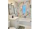 Renovated bathroom featuring a marble-tiled wall, new fixtures, and a bathtub at 2336 Nansen Ave, Orlando, FL 32817