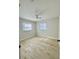 Well-lit bedroom featuring stylish floors, a ceiling fan, and two bright windows at 2336 Nansen Ave, Orlando, FL 32817
