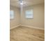 Bright bedroom featuring a ceiling fan, wood-look floors, and natural light from multiple windows at 2336 Nansen Ave, Orlando, FL 32817