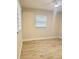 Clean, updated bedroom features wood flooring and a window offering natural light at 2336 Nansen Ave, Orlando, FL 32817