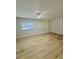 Bright, minimalist bedroom with modern wood flooring and ample natural light at 2336 Nansen Ave, Orlando, FL 32817