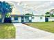 Charming single-story home with a well-maintained lawn and long driveway at 2336 Nansen Ave, Orlando, FL 32817