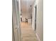 Hallway leading to kitchen featuring wood-look floors and storage closet at 2336 Nansen Ave, Orlando, FL 32817