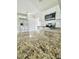 Open concept kitchen with stainless steel refrigerator, granite counters, and bright white cabinets at 2336 Nansen Ave, Orlando, FL 32817