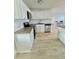 View of the updated kitchen with island, stainless steel appliances and bright white cabinets at 2336 Nansen Ave, Orlando, FL 32817