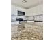 This kitchen boasts granite countertops, white cabinets, stainless steel appliances, and tile backsplash at 2336 Nansen Ave, Orlando, FL 32817